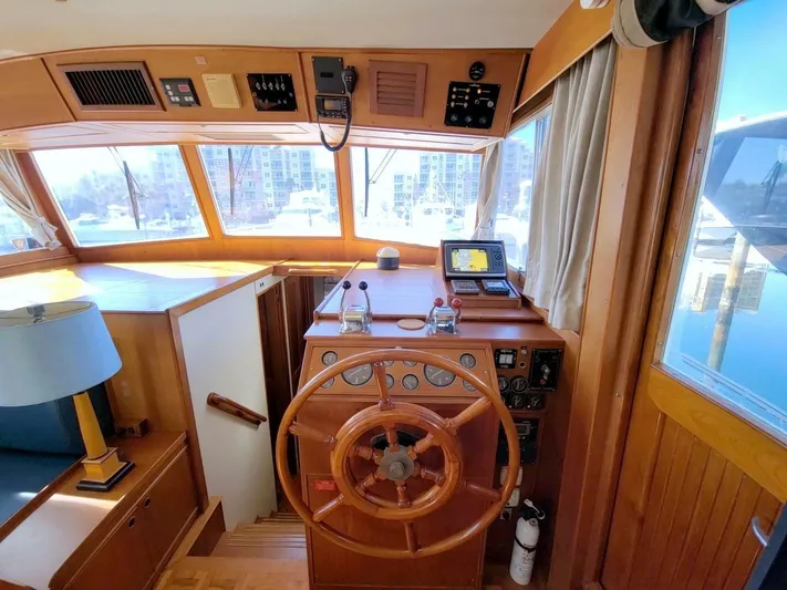 Magic Yacht Photos Pics Grand Banks 46 Europa 1996 yacht helm with wooden steering wheel and navigation equipment.