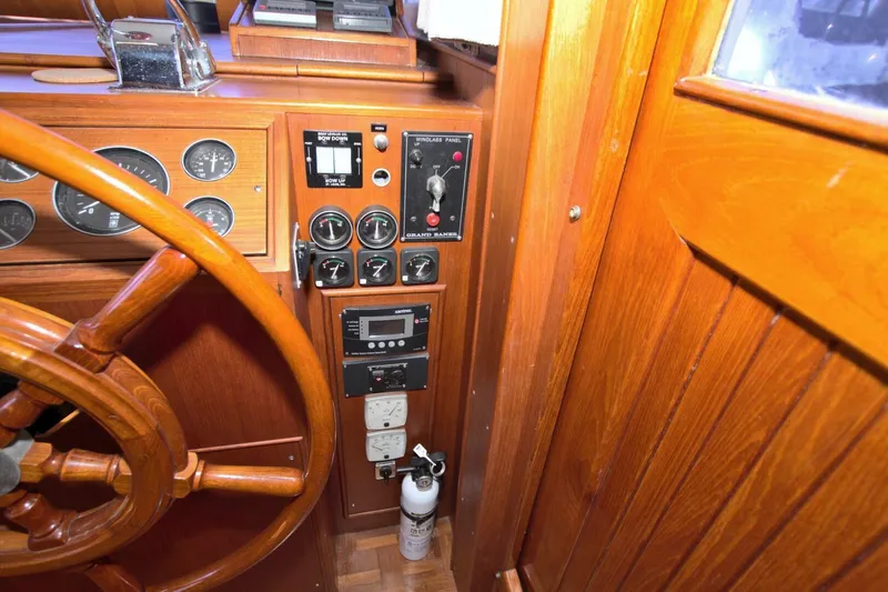 Magic Yacht Photos Pics 1996 Grand Banks 46 Europa helm with wooden steering wheel and control panel.