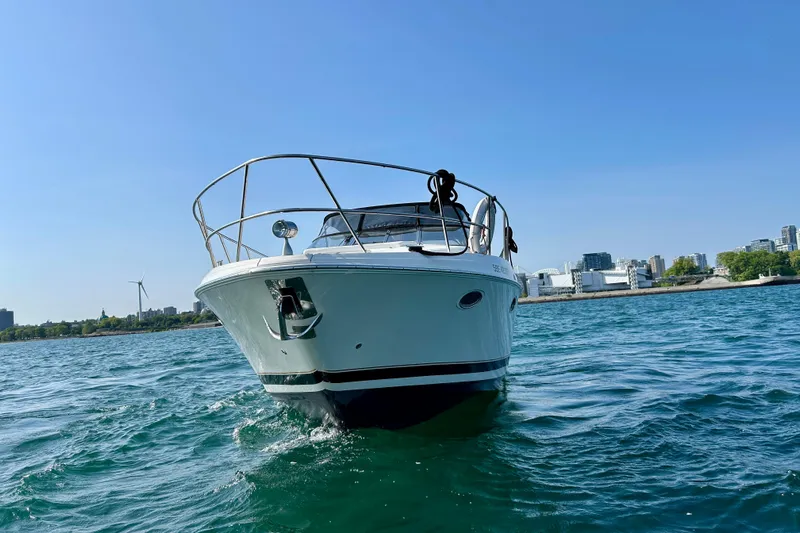Done Deal Yacht Photos Pics 2002 Regal Commodore 3860 yacht on water with city skyline in background.