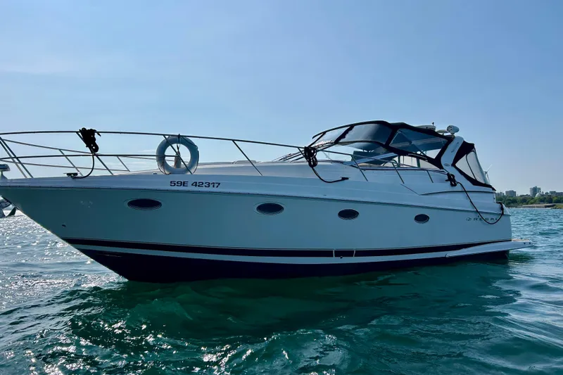 Done Deal Yacht Photos Pics 2002 Regal Commodore 3860 yacht on water, side view, clear sky background.