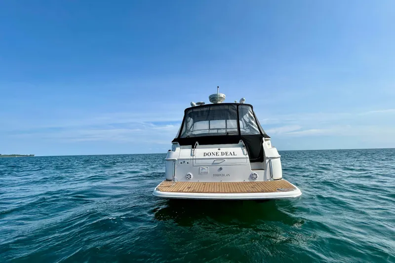 Done Deal Yacht Photos Pics 2002 Regal Commodore 3860 yacht on open water under clear blue sky.