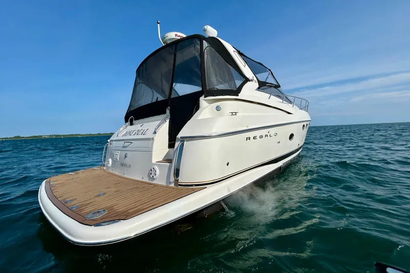 Done Deal Yacht Photos Pics 2002 Regal Commodore 3860 yacht cruising on open water under clear blue skies.