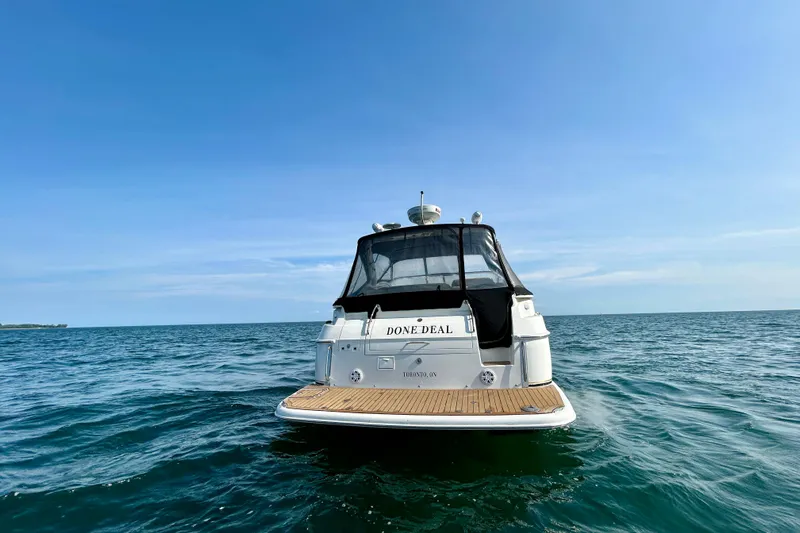 Done Deal Yacht Photos Pics 2002 Regal Commodore 3860 yacht on open water under clear blue sky.