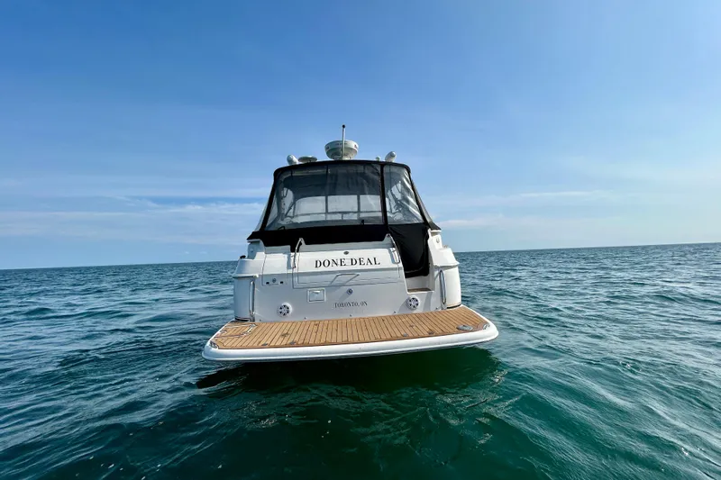 Done Deal Yacht Photos Pics 2002 Regal Commodore 3860 yacht on open sea under clear blue sky.