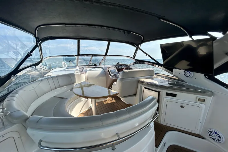 Done Deal Yacht Photos Pics Luxurious 2002 Regal Commodore 3860 yacht interior with seating, table, and ocean view.