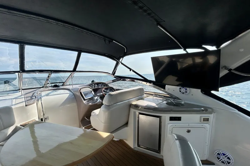 Done Deal Yacht Photos Pics Interior of 2002 Regal Commodore 3860 yacht with helm, seating, and ocean view.