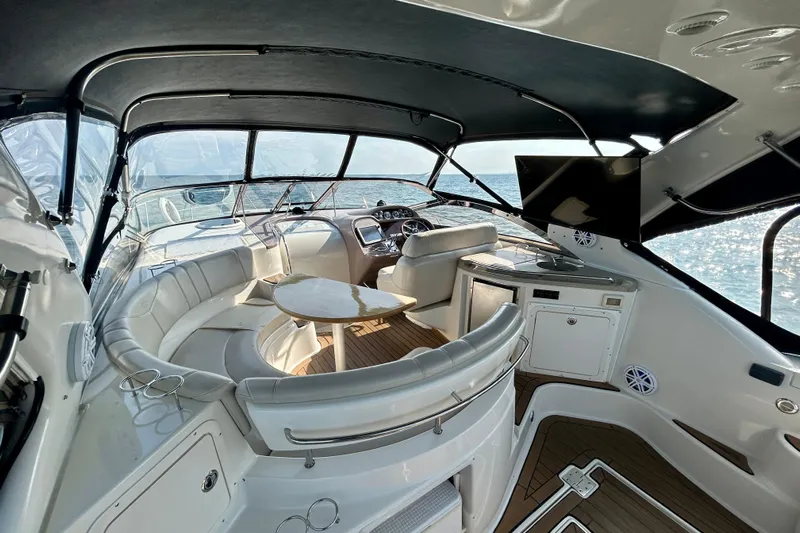 Done Deal Yacht Photos Pics Luxurious 2002 Regal Commodore 3860 yacht interior with seating, table, and ocean view.