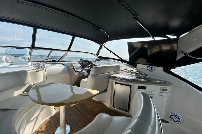 Done Deal Yacht Photos Pics Interior of 2002 Regal Commodore 3860 yacht with seating, table, and ocean view.