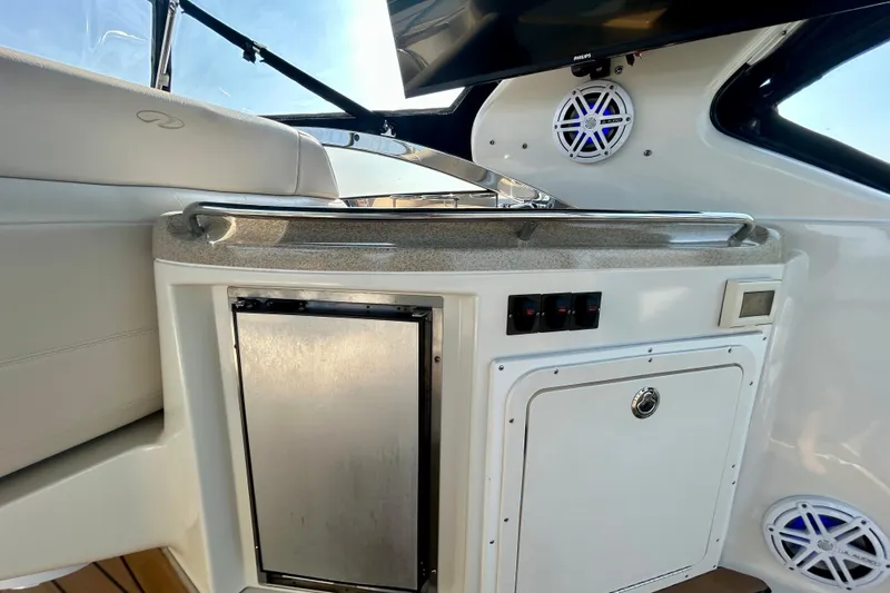 Done Deal Yacht Photos Pics 2002 Regal Commodore 3860 yacht interior with kitchenette and speaker system.