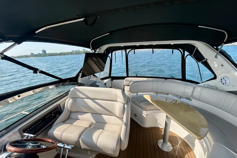 Done Deal Yacht Photos Pics Interior of 2002 Regal Commodore 3860 yacht with seating and table on open water.