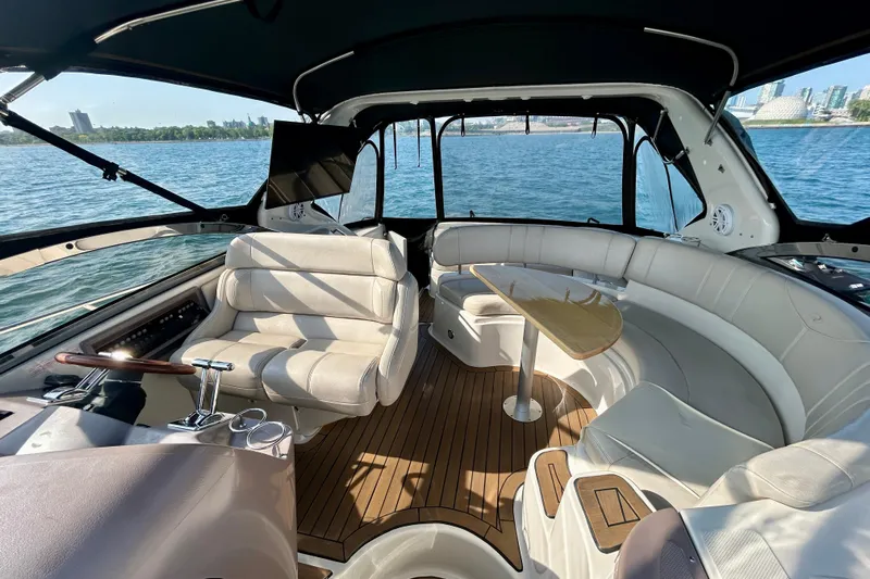 Done Deal Yacht Photos Pics Luxurious 2002 Regal Commodore 3860 yacht interior with plush seating and elegant wood flooring.