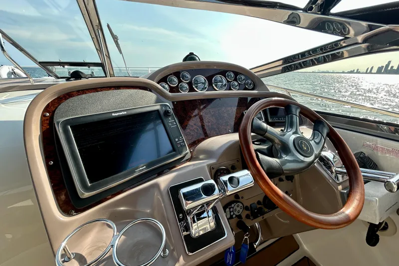 Done Deal Yacht Photos Pics Helm of 2002 Regal Commodore 3860 yacht with wooden steering wheel and navigation system.