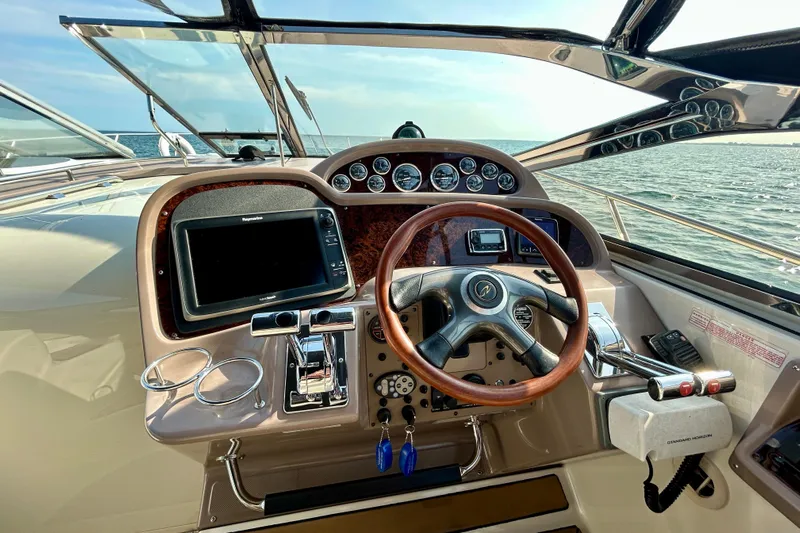 Done Deal Yacht Photos Pics Cockpit of 2002 Regal Commodore 3860 yacht with steering wheel and navigation instruments.