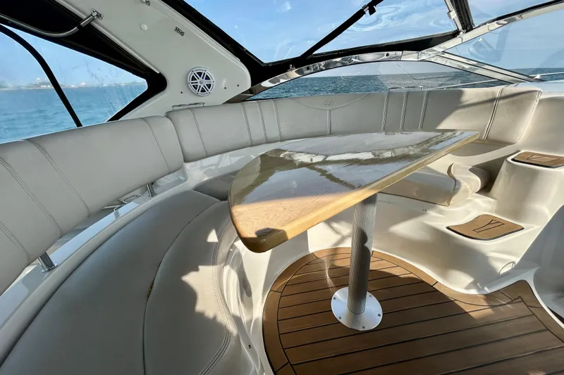 Done Deal Yacht Photos Pics Luxurious interior of 2002 Regal Commodore 3860 yacht with elegant seating and wooden table.