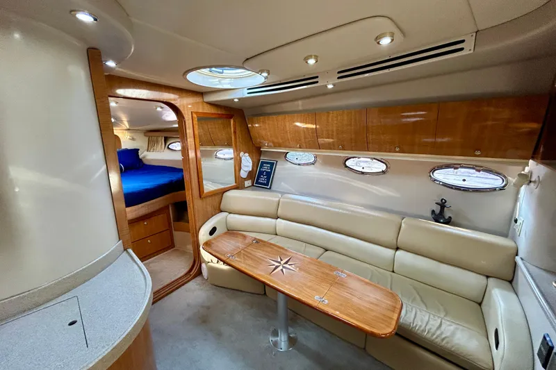 Done Deal Yacht Photos Pics Luxurious interior of 2002 Regal Commodore 3860 yacht with leather seating and wood accents.
