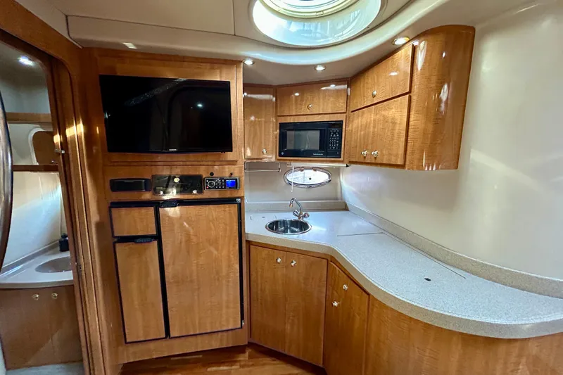 Done Deal Yacht Photos Pics Luxurious 2002 Regal Commodore 3860 yacht interior with modern kitchen amenities.