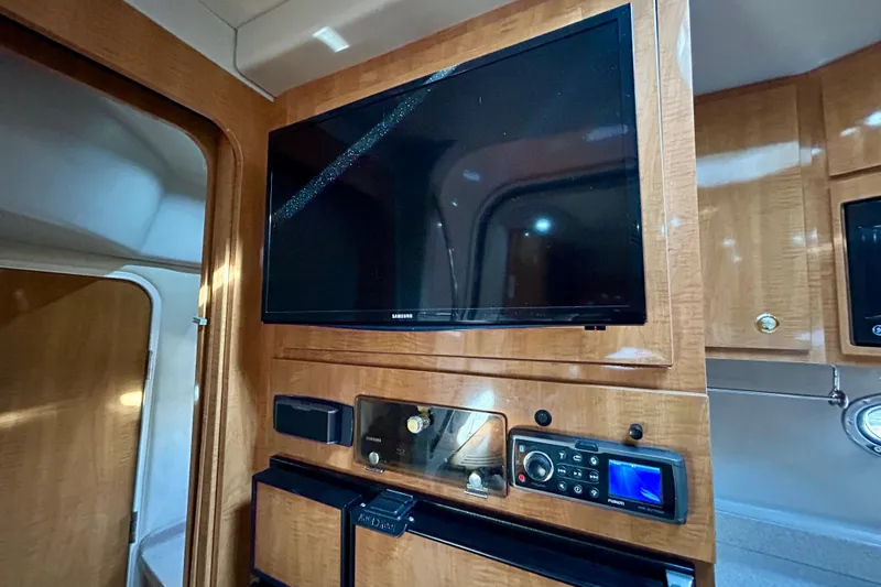Done Deal Yacht Photos Pics Interior of 2002 Regal Commodore 3860 yacht with TV and control panel.