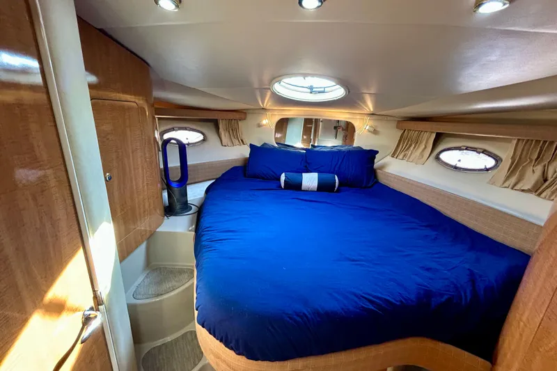 Done Deal Yacht Photos Pics Luxurious cabin interior of 2002 Regal Commodore 3860 yacht with blue bedding.