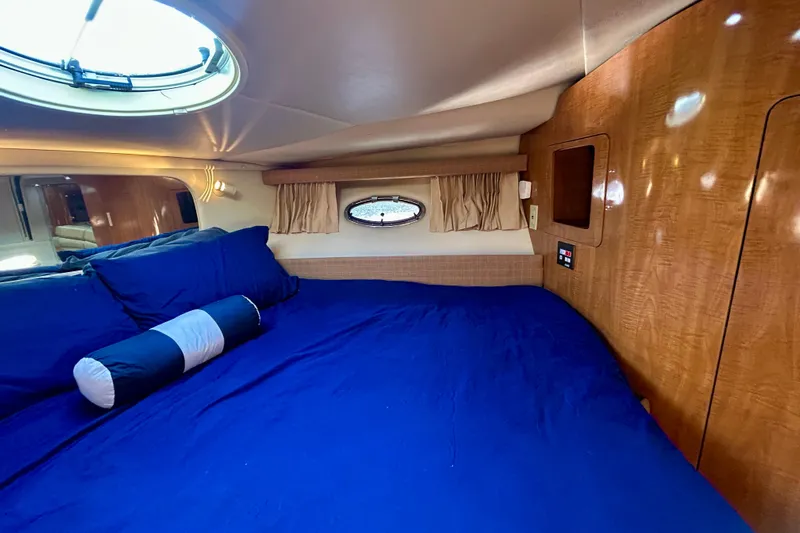 Done Deal Yacht Photos Pics Luxurious cabin interior of 2002 Regal Commodore 3860 yacht with blue bedding.