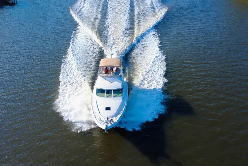 Lighten Up Yacht Photos Pics 2003 Sea Ray 400 Sedan Bridge cruising on open water, aerial view.