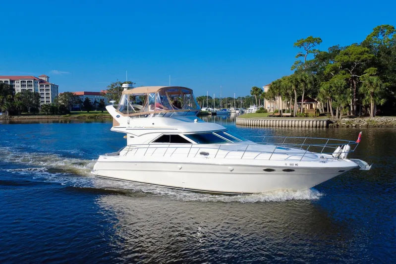 Lighten Up Yacht Photos Pics 2003 Sea Ray 400 Sedan Bridge cruising on a scenic waterway with lush greenery.