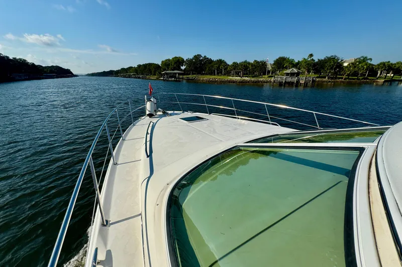 Lighten Up Yacht Photos Pics 2003 Sea Ray 400 Sedan Bridge cruising on a scenic river under a clear blue sky.