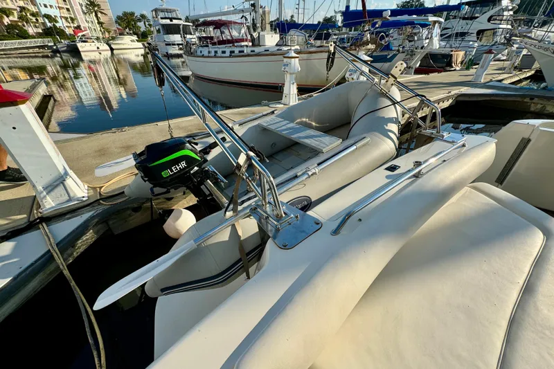Lighten Up Yacht Photos Pics 2003 Sea Ray 400 Sedan Bridge docked with inflatable boat and Lehr motor.