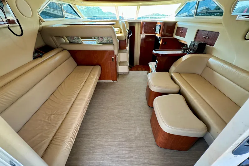 Lighten Up Yacht Photos Pics Luxurious interior of 2003 Sea Ray 400 Sedan Bridge yacht with beige leather seating.