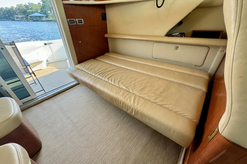 Lighten Up Yacht Photos Pics Interior of 2003 Sea Ray 400 Sedan Bridge with beige leather seating and lake view.