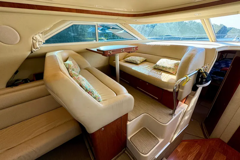 Lighten Up Yacht Photos Pics Luxurious interior of 2003 Sea Ray 400 Sedan Bridge with plush seating and elegant design.