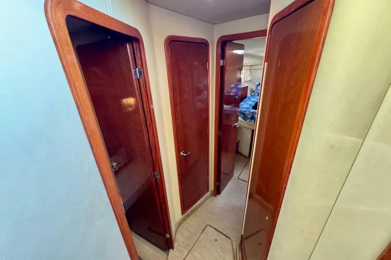 Lighten Up Yacht Photos Pics Interior hallway of 2003 Sea Ray 400 Sedan Bridge with wooden doors and cozy cabin.