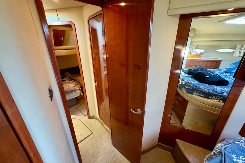 Lighten Up Yacht Photos Pics Interior of 2003 Sea Ray 400 Sedan Bridge, featuring wood finishes and cozy cabin spaces.
