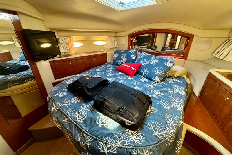 Lighten Up Yacht Photos Pics Luxurious cabin interior of 2003 Sea Ray 400 Sedan Bridge yacht with cozy bedding.
