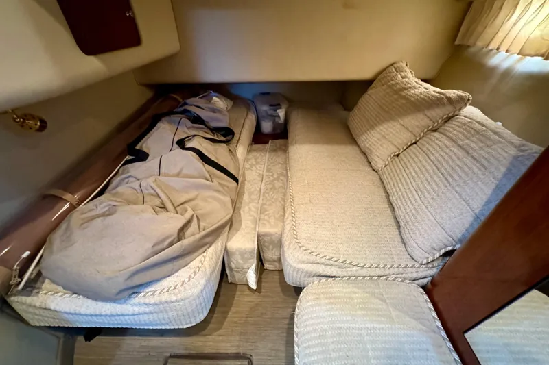 Lighten Up Yacht Photos Pics Interior cabin of 2003 Sea Ray 400 Sedan Bridge with cozy bedding and cushions.