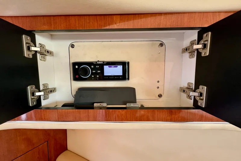 Lighten Up Yacht Photos Pics Cabinet interior with Fusion stereo system on 2003 Sea Ray 400 Sedan Bridge yacht.