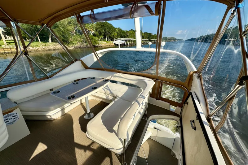 Lighten Up Yacht Photos Pics 2003 Sea Ray 400 Sedan Bridge interior with scenic waterway view.