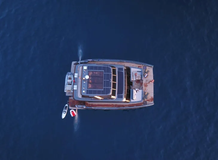 Double Happiness Yacht Photos Pics Aerial view of 2024 Sunreef 60 yacht on calm blue water.