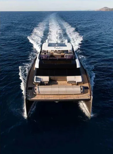 Double Happiness Yacht Photos Pics 2024 Sunreef 60 yacht cruising on open sea, aerial rear view.