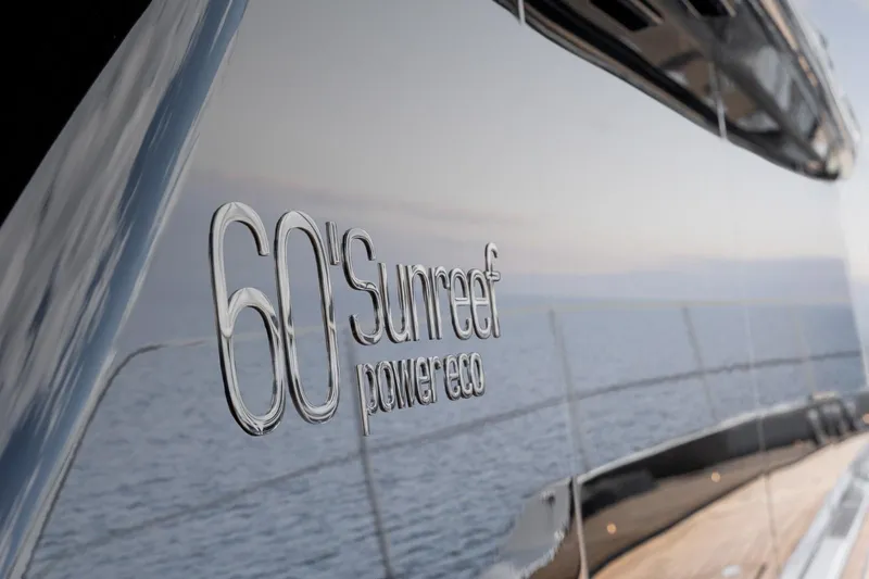 Double Happiness Yacht Photos Pics 2024 Sunreef 60 yacht with 'power eco' branding, reflecting ocean view.