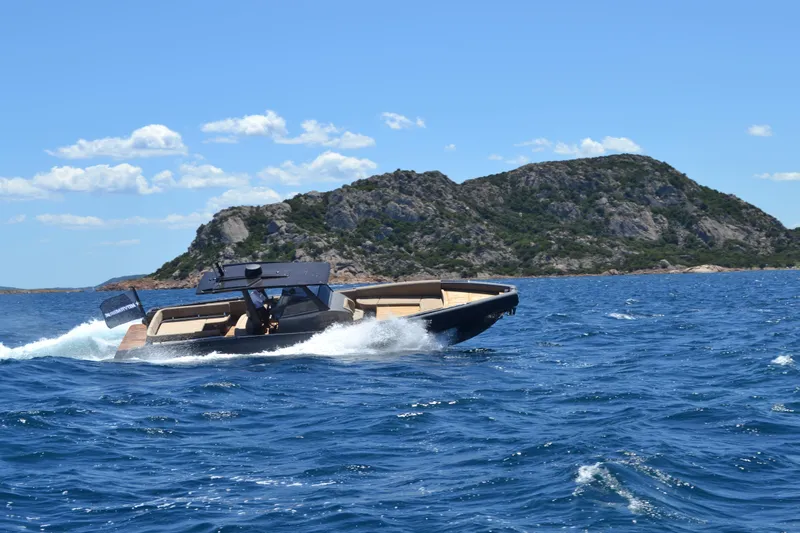 Black Shiver 120 Efb Yacht Photos Pics 2025 Novamarine Black Shiver 120 Diesel cruising on blue ocean near rocky island.