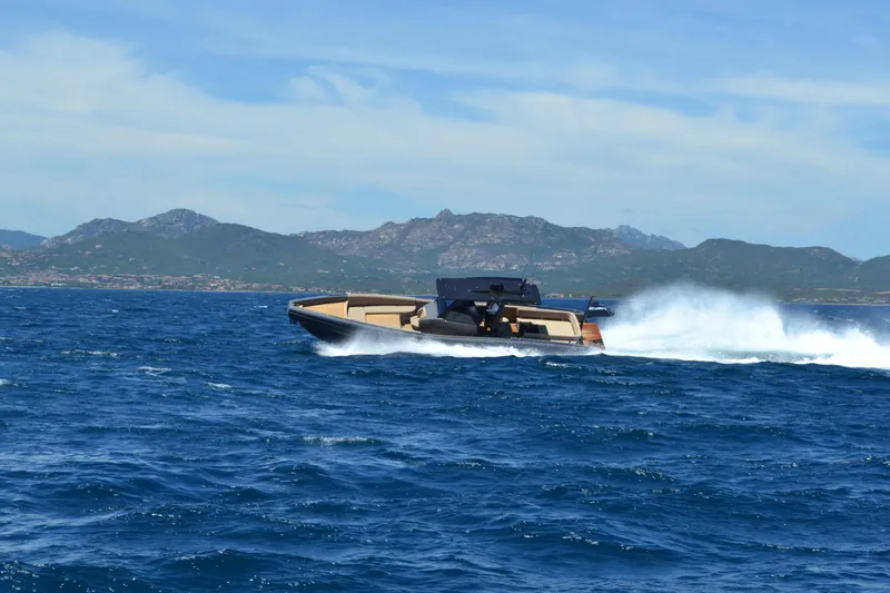 Black Shiver 120 Efb Yacht Photos Pics Novamarine Black Shiver 120 Diesel 2025 cruising on open sea with mountainous backdrop.