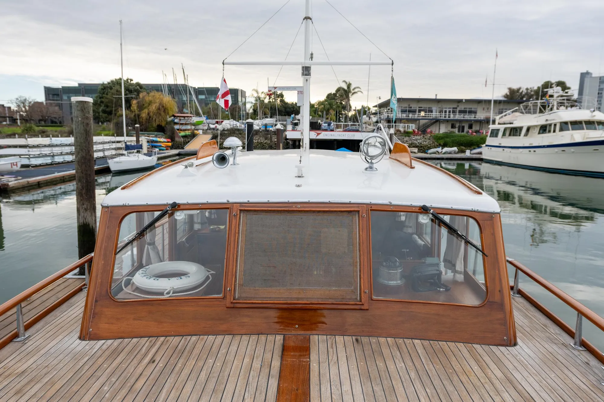 1939 Stephens Brothers Bridgedeck Cruiser docked at marina, showcasing classic wooden design.