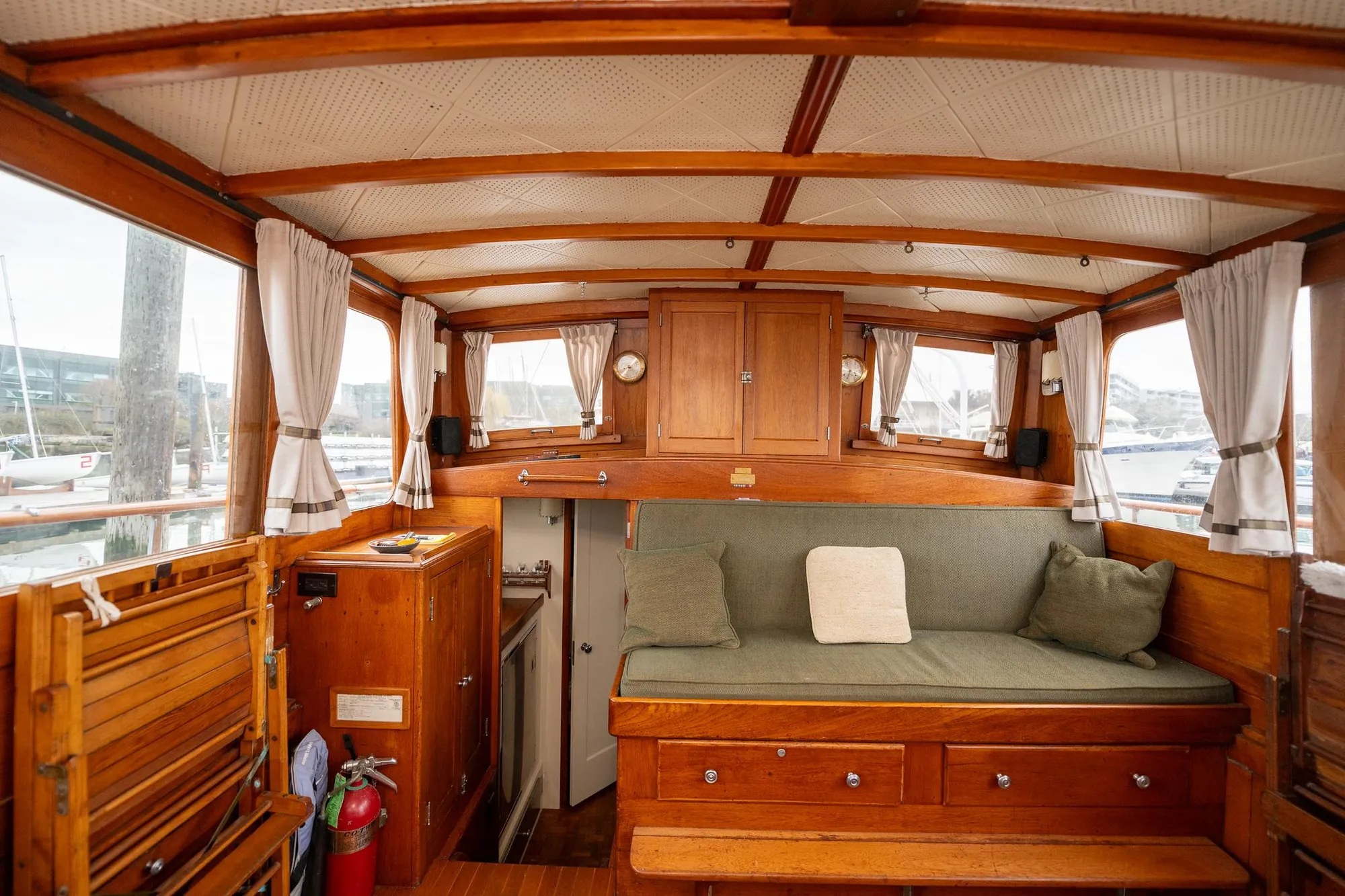 Interior of 1939 Stephens Brothers Bridgedeck Cruiser with wooden furnishings and cozy seating.