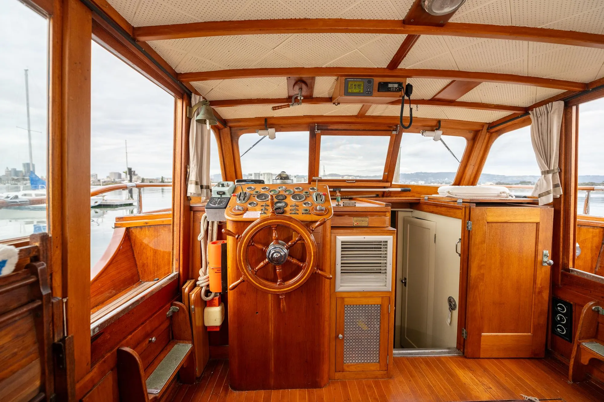 1939 Stephens Brothers Bridgedeck Cruiser interior with wooden helm and classic design.