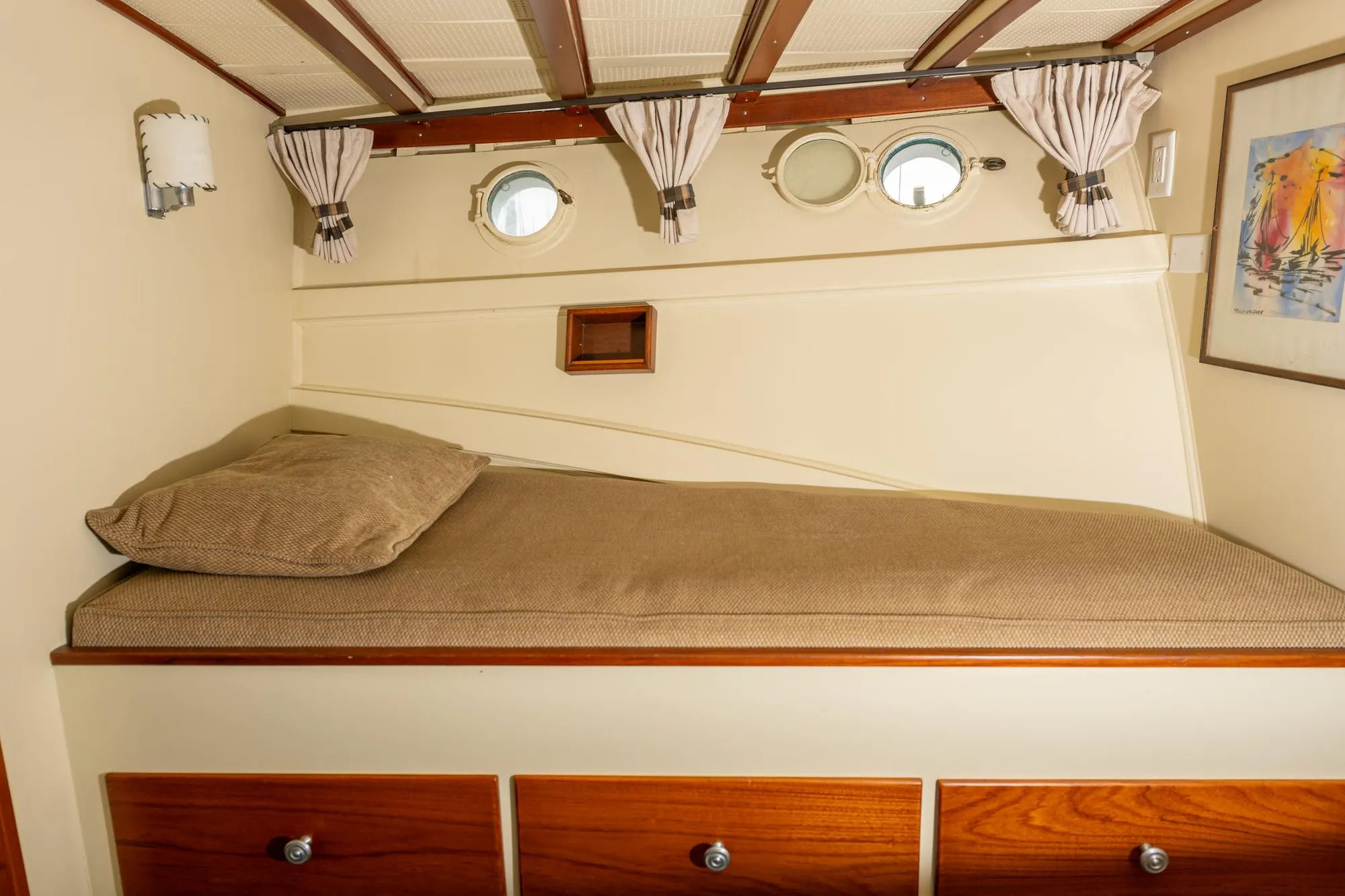 1939 Stephens Brothers Bridgedeck Cruiser cabin interior with bed and portholes.