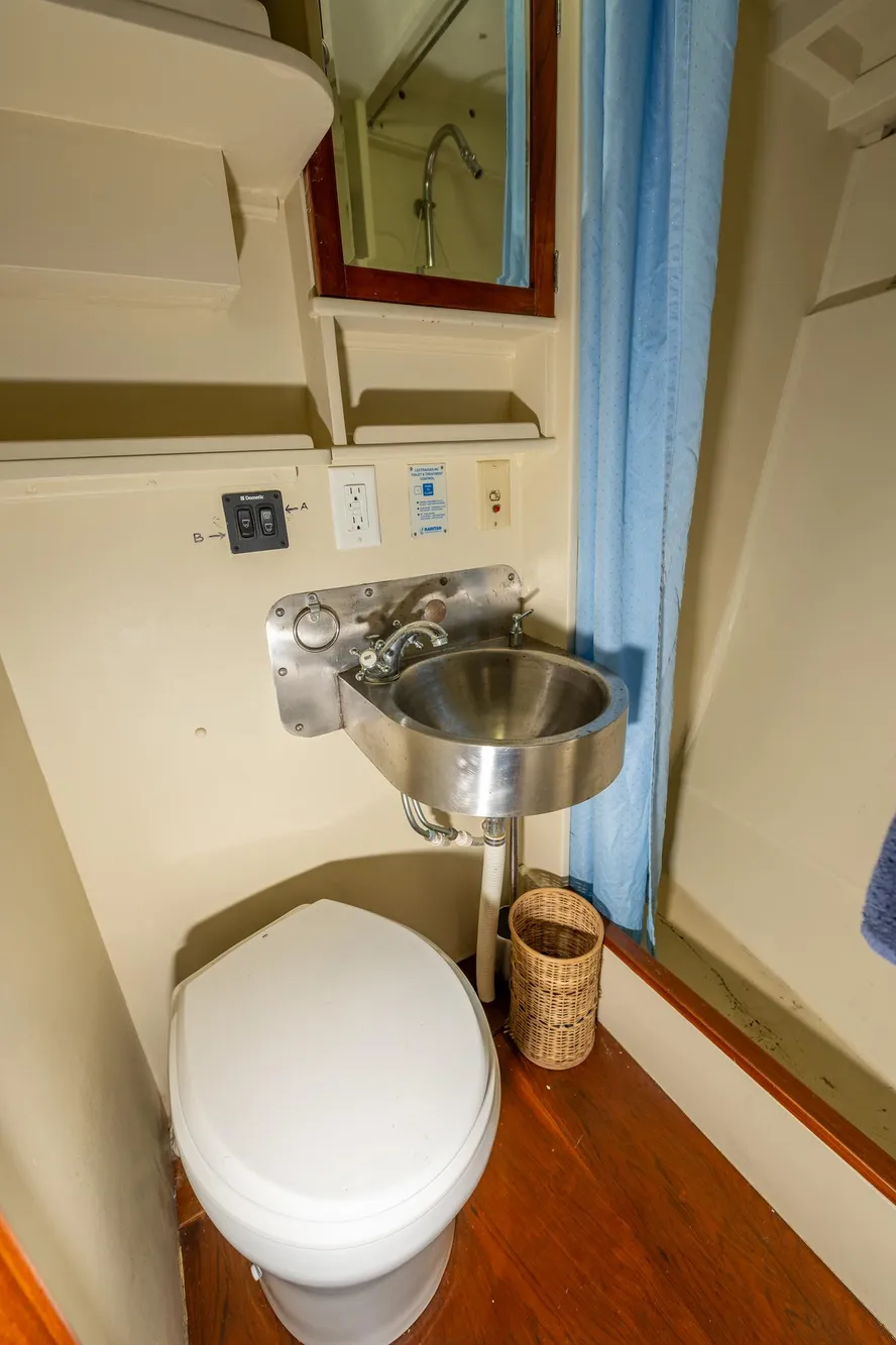 1939 Stephens Brothers Bridgedeck Cruiser bathroom with stainless steel sink and toilet.