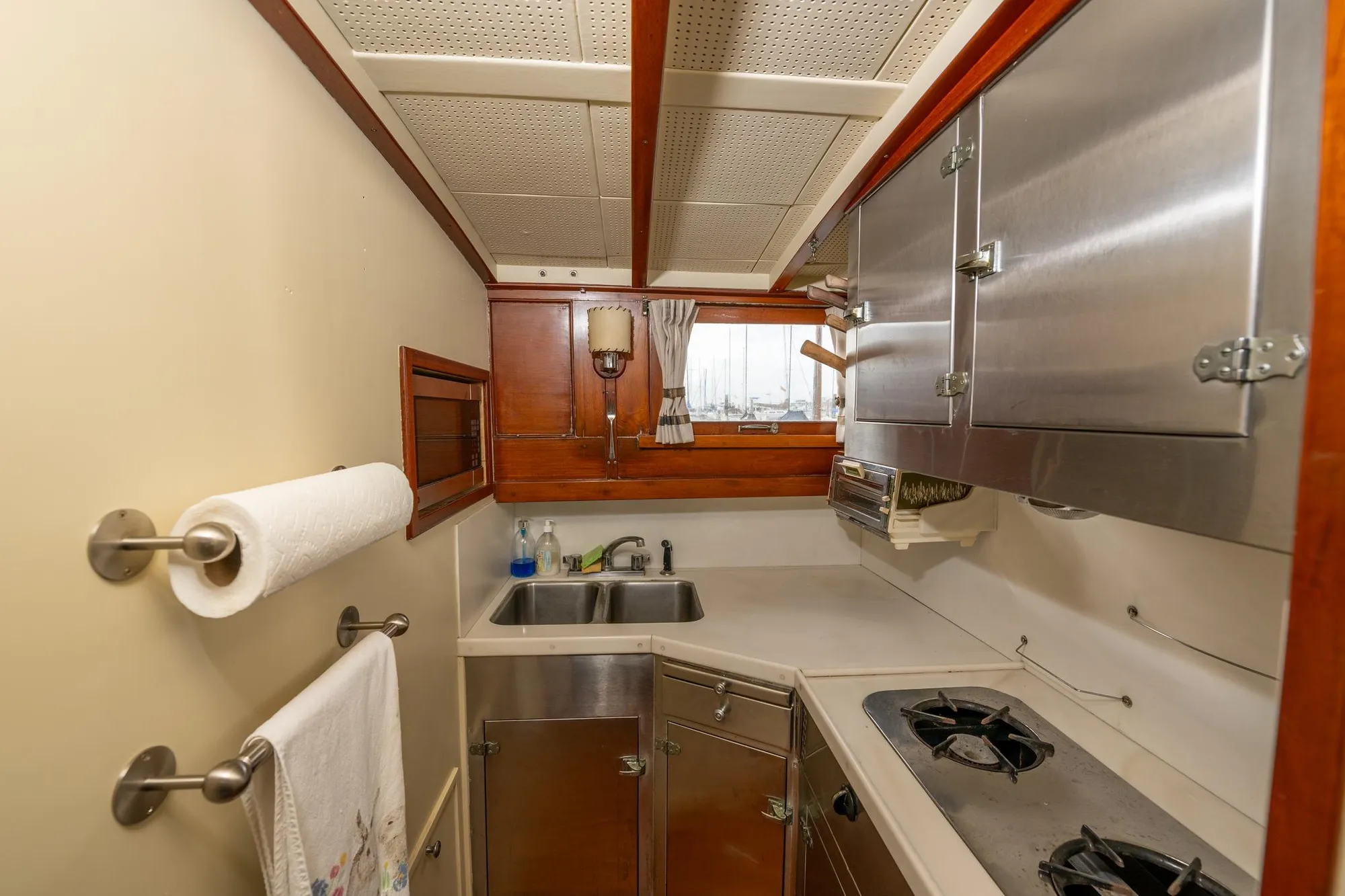 1939 Stephens Brothers Bridgedeck Cruiser kitchen with stainless steel appliances and wooden accents.