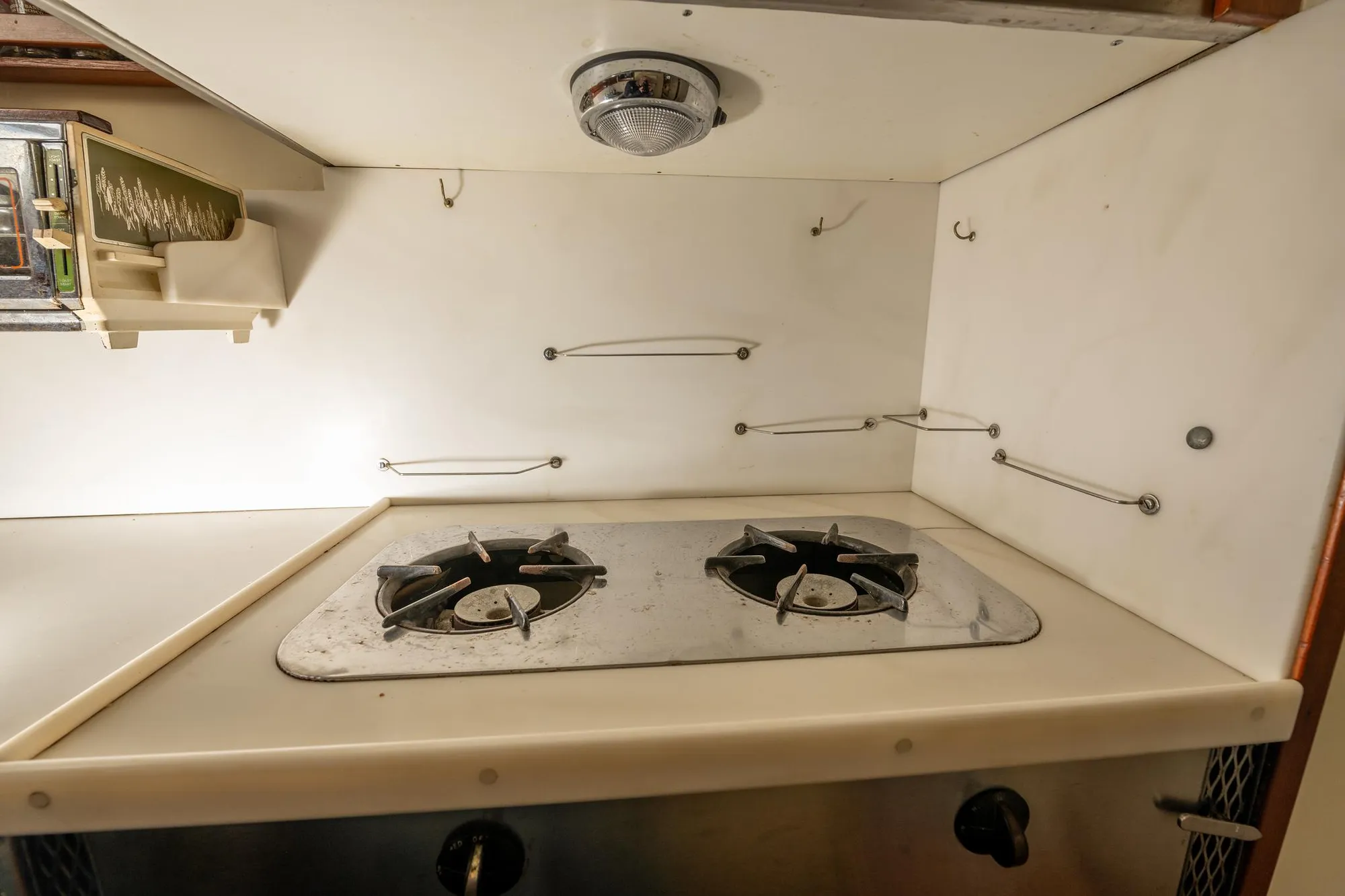 1939 Stephens Brothers Bridgedeck Cruiser kitchen with vintage stove and storage.