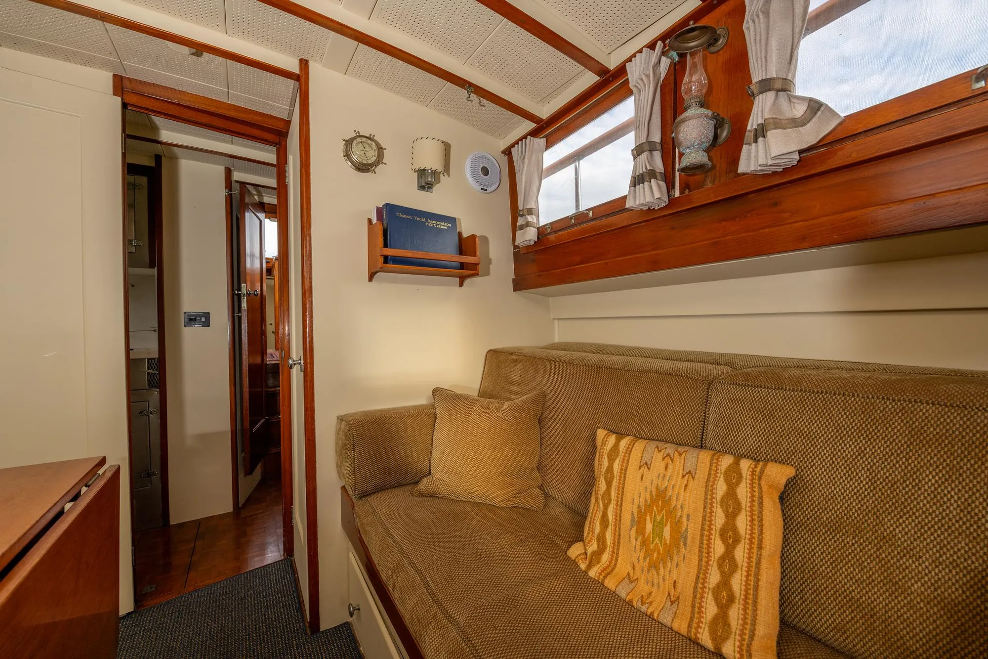 Interior of 1939 Stephens Brothers Bridgedeck Cruiser with cozy seating and vintage decor.