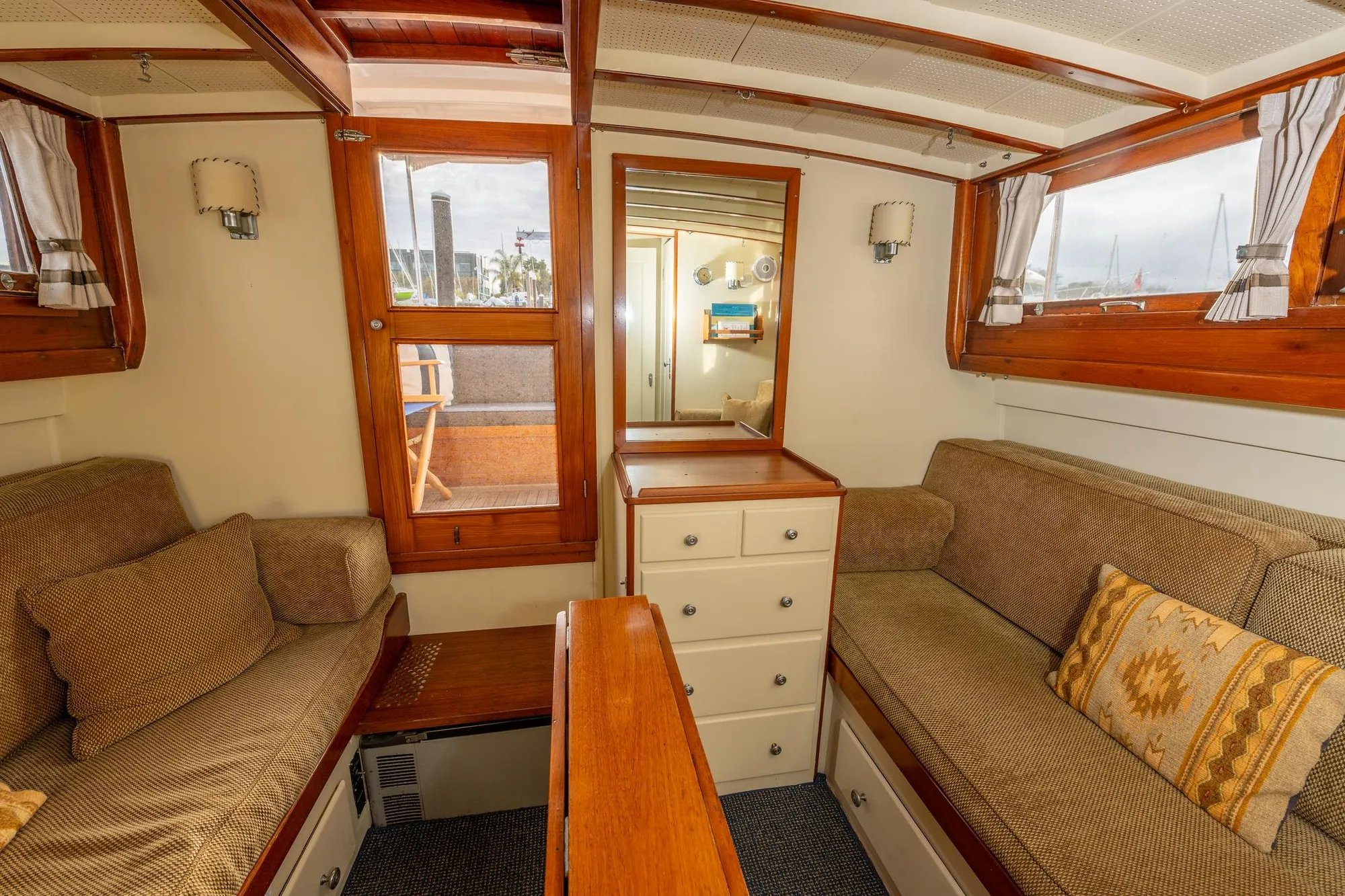 Interior of 1939 Stephens Brothers Bridgedeck Cruiser with cozy seating and wooden accents.